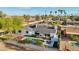 Aerial view of a backyard featuring a sparkling in-ground pool with a small spa and a covered patio, perfect for outdoor entertaining at 8730 E Montecito Ave, Scottsdale, AZ 85251