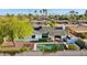 Aerial view of a backyard featuring a sparkling in-ground pool with a small spa and a covered patio, perfect for outdoor entertaining at 8730 E Montecito Ave, Scottsdale, AZ 85251