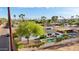 Aerial view of a backyard featuring a sparkling in-ground pool with a small spa and a covered patio, perfect for outdoor entertaining at 8730 E Montecito Ave, Scottsdale, AZ 85251