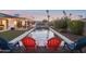 Backyard featuring a sparkling pool with a hot tub, lush greenery, and swaying palm trees at 8730 E Montecito Ave, Scottsdale, AZ 85251