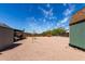 Spacious backyard with gravel, storage sheds and a windmill at 930 E Friar Ave, Apache Junction, AZ 85119