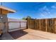 Fenced backyard featuring a mix of white and natural wood fencing and a gravel ground cover at 930 E Friar Ave, Apache Junction, AZ 85119
