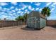 Backyard with a shed and chain link fence at 930 E Friar Ave, Apache Junction, AZ 85119
