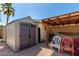 Backyard with a shed and covered patio at 930 E Friar Ave, Apache Junction, AZ 85119