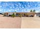 Single-story home featuring desert landscaping, a driveway, and blue skies with wispy clouds at 930 E Friar Ave, Apache Junction, AZ 85119