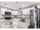 Modern kitchen featuring stainless steel appliances and granite countertops, with white cabinets and an island at 930 E Friar Ave, Apache Junction, AZ 85119