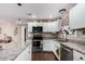 Bright kitchen featuring granite countertops, stainless steel appliances, and white cabinetry at 930 E Friar Ave, Apache Junction, AZ 85119
