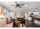 Open-concept living area with a kitchen, dark wood floors, and neutral-toned walls at 930 E Friar Ave, Apache Junction, AZ 85119