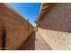 Narrow side yard featuring a tall block wall and a gate leading to the backyard at 930 E Friar Ave, Apache Junction, AZ 85119