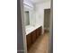 Bathroom features double sinks, wood cabinets, tile flooring, and a toilet at 9556 W Blue Sky Dr, Peoria, AZ 85383