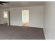 Bedroom with carpet and a view into the bathroom with a walk-in shower and a freestanding soaking tub at 9556 W Blue Sky Dr, Peoria, AZ 85383