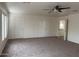 Bedroom with carpet, ceiling fan, white walls, and a door to a walk-in closet offering a serene and organized space at 9556 W Blue Sky Dr, Peoria, AZ 85383