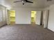 Bedroom boasts carpet, a ceiling fan, an abundance of closet space and natural light through the window shutters at 9556 W Blue Sky Dr, Peoria, AZ 85383