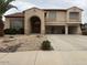 Charming two-story home featuring an arched entrance and a spacious three-car garage at 9556 W Blue Sky Dr, Peoria, AZ 85383