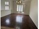 Bright living room with hardwood floors, large windows and modern chandelier at 9556 W Blue Sky Dr, Peoria, AZ 85383