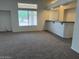 Open living room with carpet and bar seating at 9556 W Blue Sky Dr, Peoria, AZ 85383