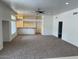 Open-concept living room with carpet flooring and abundant natural light at 9556 W Blue Sky Dr, Peoria, AZ 85383