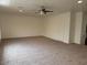 Large open living area with plush carpet and ceiling fan, offering a comfortable space at 9556 W Blue Sky Dr, Peoria, AZ 85383