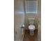 Powder room featuring a standard white toilet, neutral walls, blinds and an adjacent door at 9556 W Blue Sky Dr, Peoria, AZ 85383