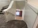 Carpeted staircase leading to a lower level with wood and tile flooring at 9556 W Blue Sky Dr, Peoria, AZ 85383