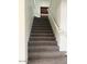 Carpeted staircase with white railings, leading to the upper level at 9556 W Blue Sky Dr, Peoria, AZ 85383
