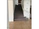 Carpeted staircase with white railings, providing access to the upper level at 9556 W Blue Sky Dr, Peoria, AZ 85383