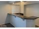 Wet bar with granite countertop and dark wood cabinets at 9556 W Blue Sky Dr, Peoria, AZ 85383
