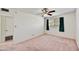 Simple bedroom with a ceiling fan, a large window, and neutral walls at 9635 W Ironwood Dr # B, Peoria, AZ 85345