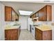 Functional kitchen with ample cabinet space, white appliances, and good lighting at 9635 W Ironwood Dr # B, Peoria, AZ 85345