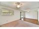 Bright living room with wood floors, sliding door access, and dual ceiling fans at 9635 W Ironwood Dr # B, Peoria, AZ 85345