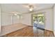 Bright living room with wood floors, sliding door access, and dual ceiling fans at 9635 W Ironwood Dr # B, Peoria, AZ 85345