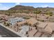 Expansive aerial view of a desert home, with a long driveway and meticulous desert landscaping at 10040 E Grandview St, Mesa, AZ 85207