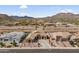 Breathtaking aerial view highlighting the home's desert surroundings and meticulously designed landscaping at 10040 E Grandview St, Mesa, AZ 85207