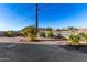 A landscaped backyard with shrubbery and concrete patio stones, offering outdoor living space at 10040 E Grandview St, Mesa, AZ 85207