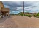 Spacious backyard with desert landscaping, a covered patio, and mountain views at 10040 E Grandview St, Mesa, AZ 85207