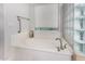 Well-lit bathroom features a soaking tub with glass block accents and neutral finishes at 10040 E Grandview St, Mesa, AZ 85207