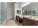 Well-lit bathroom featuring double sinks, glass block accents, tile floors, and modern fixtures at 10040 E Grandview St, Mesa, AZ 85207