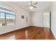 Bright bedroom boasts hardwood floors, large windows, and modern ceiling fan with decorative light fixture at 10040 E Grandview St, Mesa, AZ 85207