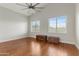 Empty bedroom featuring hardwood floors, a vaulted ceiling, and large windows that bring in natural light at 10040 E Grandview St, Mesa, AZ 85207