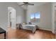 Cozy bedroom featuring vaulted ceiling, chandelier, hardwood floors, and large window at 10040 E Grandview St, Mesa, AZ 85207