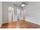 Bright bedroom featuring hardwood floors, chandelier, walk-in closet, and bathroom access at 10040 E Grandview St, Mesa, AZ 85207