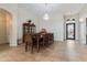 Open-concept dining room with elegant chandelier, tile floors, and decorative china cabinet at 10040 E Grandview St, Mesa, AZ 85207