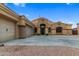Single-story home boasting attached garages, desert landscaping, and private driveway at 10040 E Grandview St, Mesa, AZ 85207