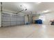Spacious garage with multiple doors, ample storage, and epoxy floors offers parking and project space at 10040 E Grandview St, Mesa, AZ 85207