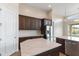 Bright eat-in kitchen featuring stainless steel appliances, quartz countertops, and dark wood cabinets at 10040 E Grandview St, Mesa, AZ 85207