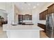 Spacious kitchen featuring stainless steel appliances, dark cabinetry, and a large island with quartz countertops at 10040 E Grandview St, Mesa, AZ 85207