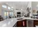 Open-concept kitchen with stainless steel appliances, white countertops, dark cabinetry, and a sink at 10040 E Grandview St, Mesa, AZ 85207