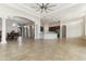 Open-concept great room with columns, archways, tile floors, and access to dining and kitchen at 10040 E Grandview St, Mesa, AZ 85207