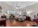 Spacious main bedroom with vaulted ceiling, ceiling fan, wood floors and natural light from windows at 10040 E Grandview St, Mesa, AZ 85207
