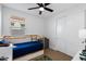 Cozy bedroom with a twin bed, natural light, closet, and a whimsical rug, creating a cheerful atmosphere at 10714 E Lincoln Ave, Mesa, AZ 85212